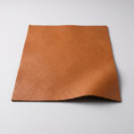 Swatch of cognac tan soft grain automotive upholstery leather
