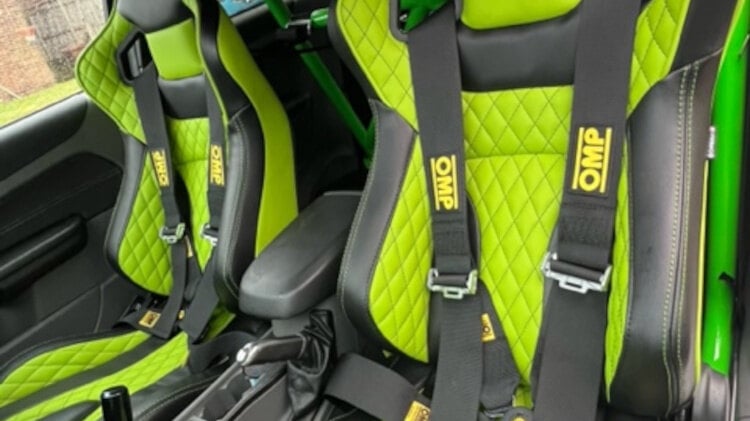 Black and lime green Corbeau RRS Elite reclining seats with diamond stitching and OMP harnesses in a customer car with a green roll cage