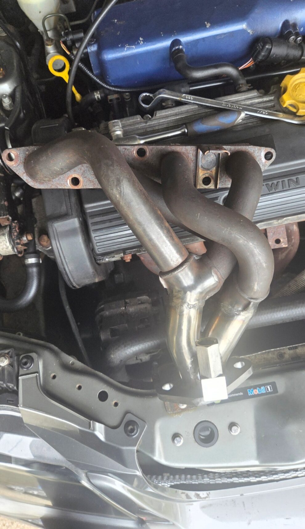 A tubular stainless steel exhaust manifold fitted to the Rover K Series engine in the MG ZS