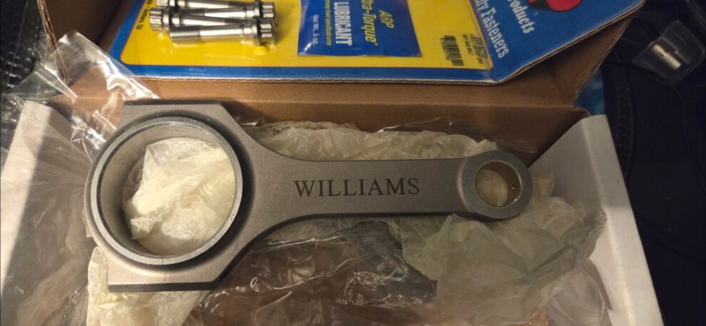 A forged Williams connecting rod and a set of ARP bolts in their packaging, the first parts bought for a turbocharged Rover K Series build