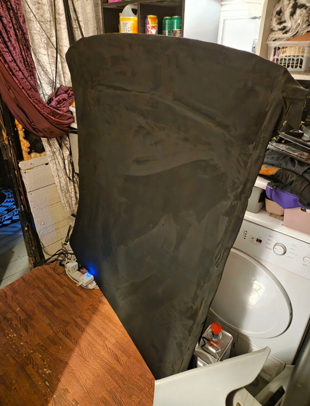 The MG ZS headliner board being rewrapped in fabric, resting across a washing machine in a utility room
