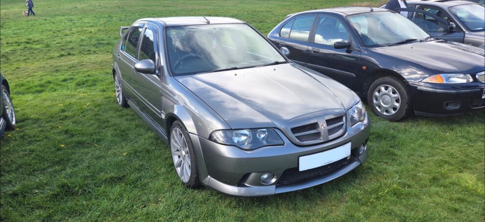 The MG ZS parked on grass at the Pride of Longbridge show in 2026 alongside a row of other Rover group cars