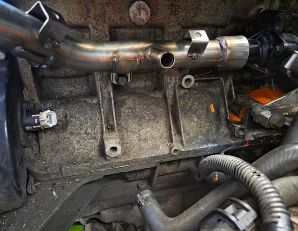 A stainless steel coolant rail fitted to the Rover K Series engine in the MG ZS