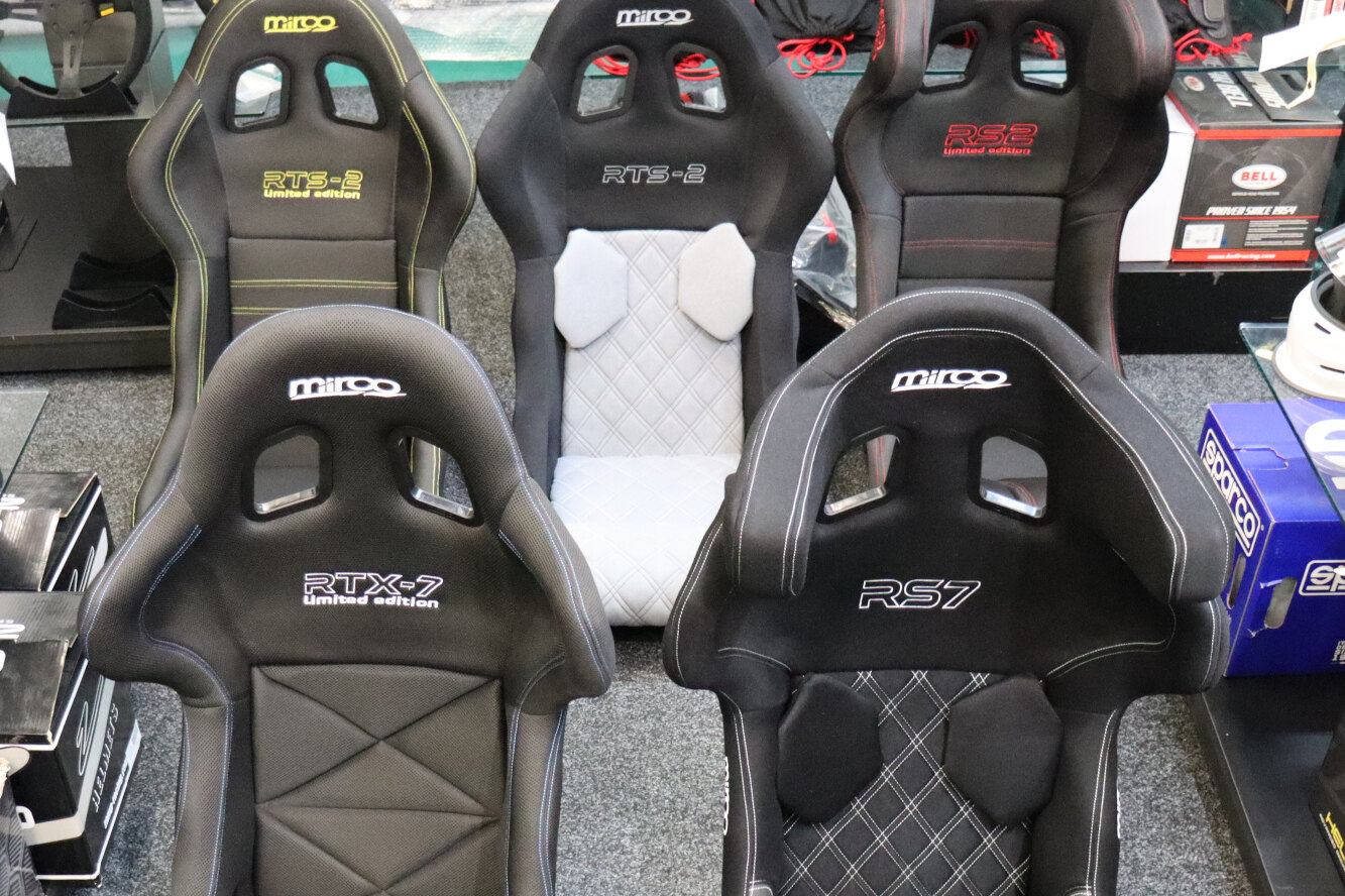 Five black Mirco FIA bucket seats on the showroom floor, including RTS-2, RS2, RTX-7 and RS7 models