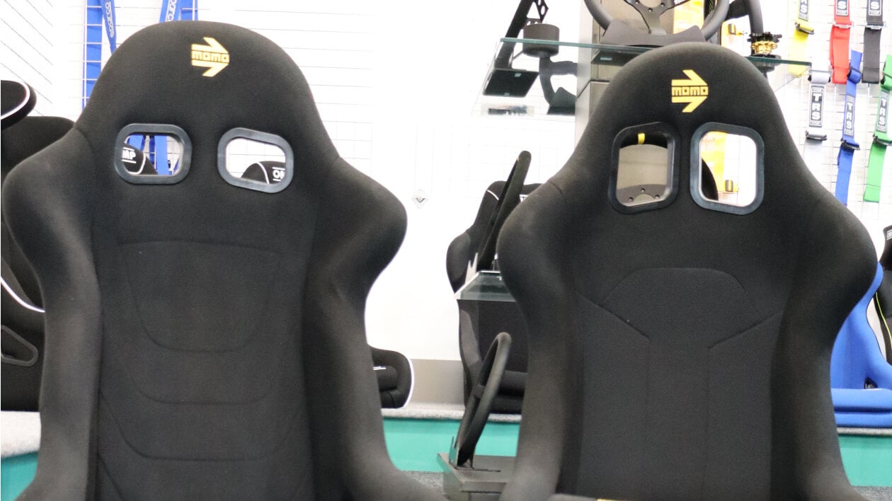 A black Momo Start and a black Momo Super Cup bucket seat side by side in the showroom