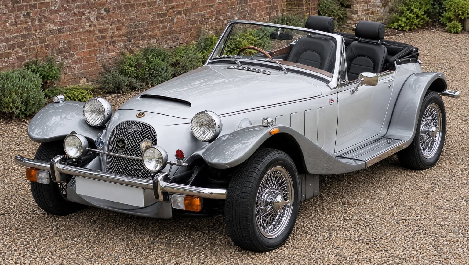 Silver Panther Kallista with the roof down and a pair of black vinyl Corbeau Sportsman reclining seats in the cockpit