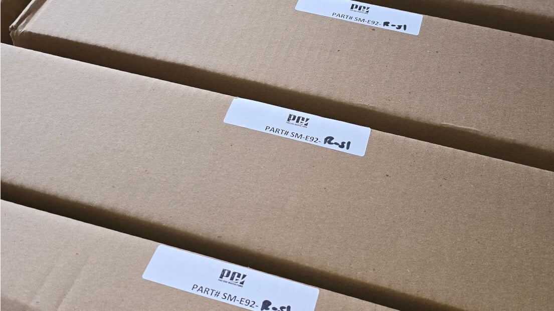 Cardboard boxes of PCI Racing seat frames labelled with part number SM-E92 R-S1, from a delivery in June 2024
