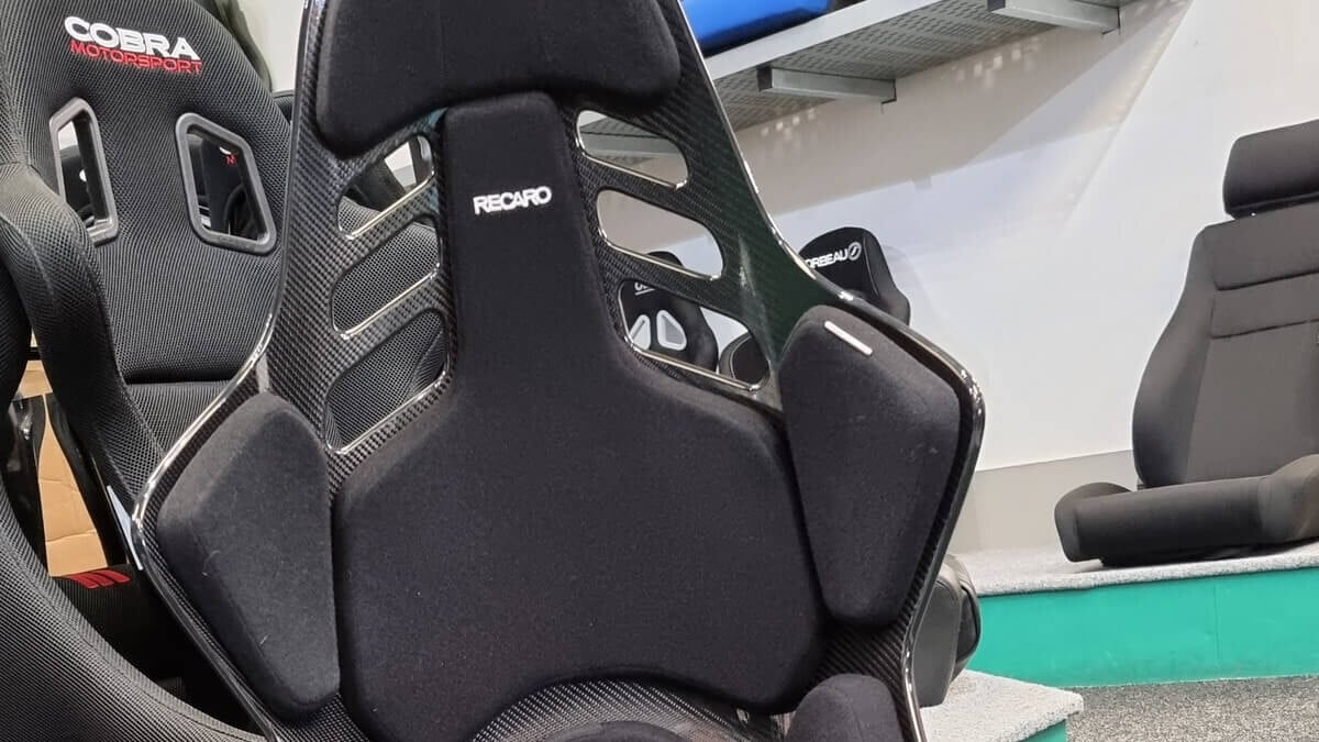 The black velour pads and carbon shell of a Recaro Podium seat in the GSM Performance showroom