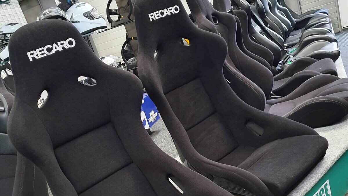 Two black velour Recaro Pole Position bucket seats on the display plinth in the GSM Performance showroom