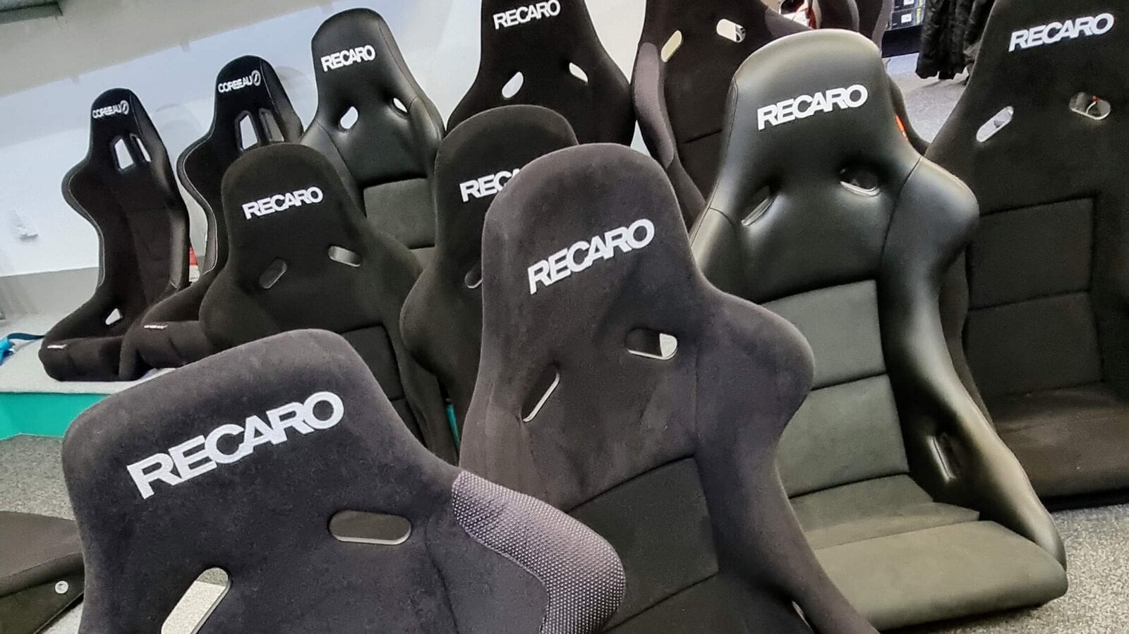 Rows of black Recaro Pole Position and Profi SPG bucket seats on the GSM Performance showroom floor