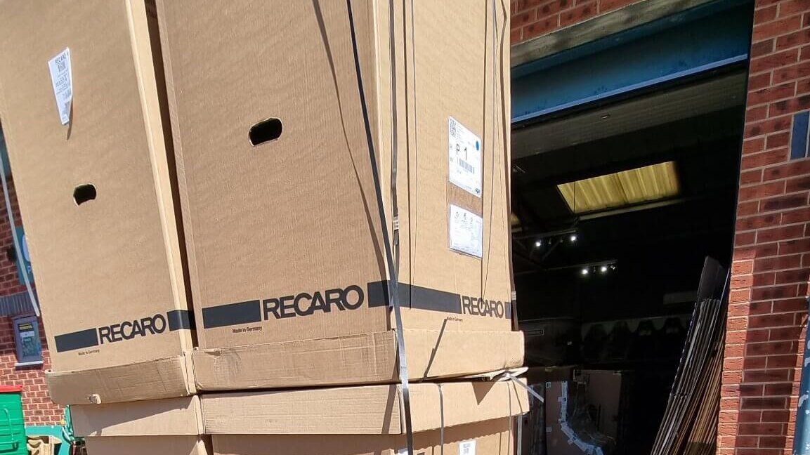 Stacked Recaro seat boxes on a pallet outside our unit