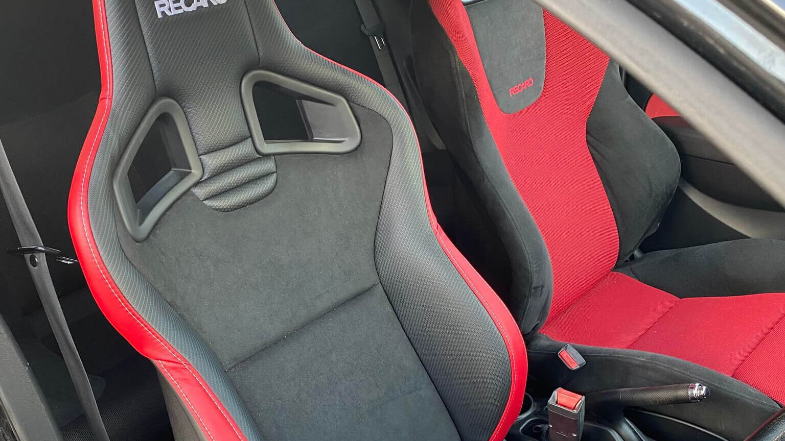 A Recaro Sportster CS Performance Edition with red side stripes fitted in a customer's car