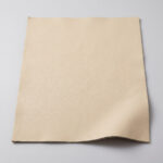 Swatch of sand beige soft grain automotive upholstery leather