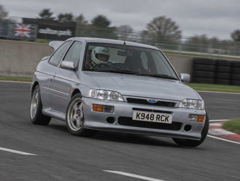 Silver Seat Cordoba Mk1 two-door coupe cornering at a British club racing circuit