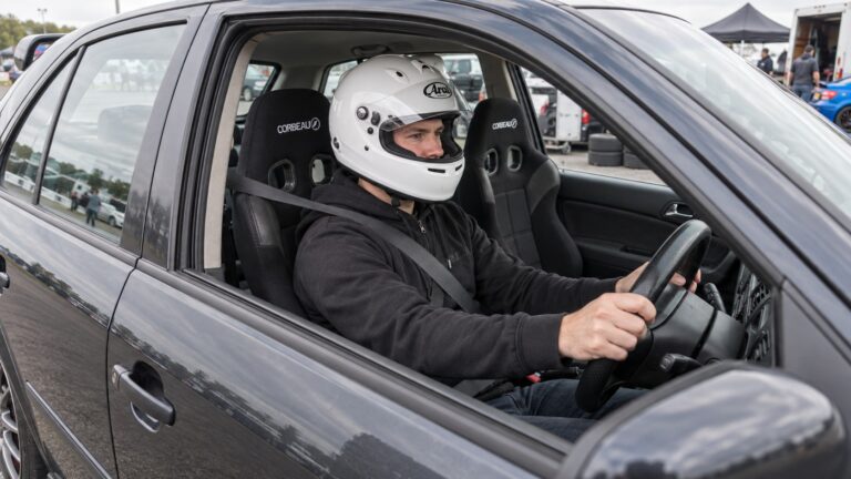 Helmeted driver in a Skoda Octavia Mk1 fitted with black Corbeau PSR reclining sport seats