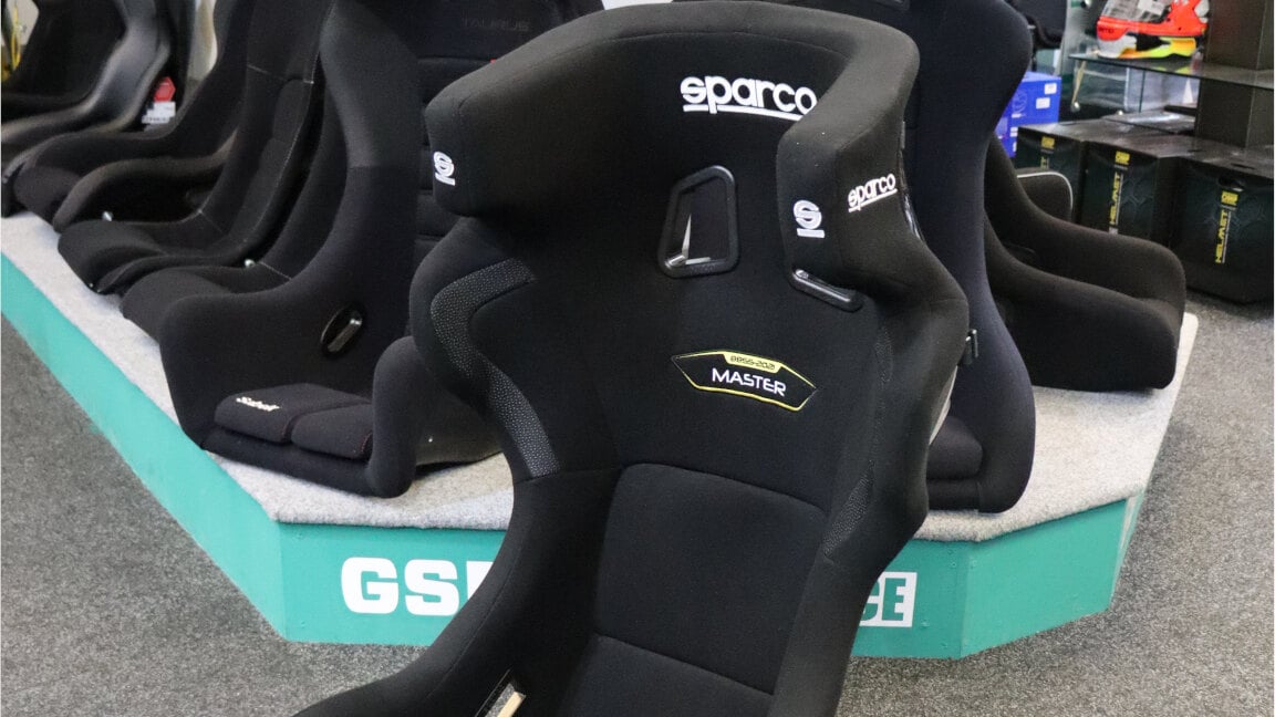 A black Sparco Master FIA bucket seat on the showroom floor in front of the GSM Performance seat display