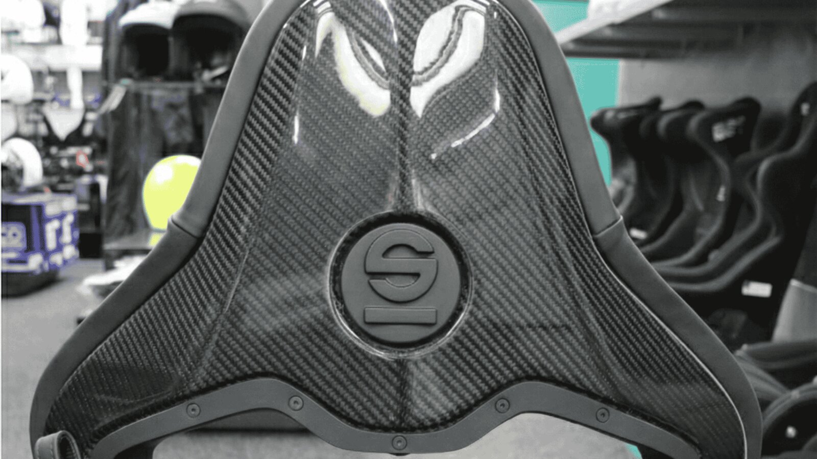 The gloss carbon fibre back of a Sparco SPX reclining seat in the GSM Performance showroom