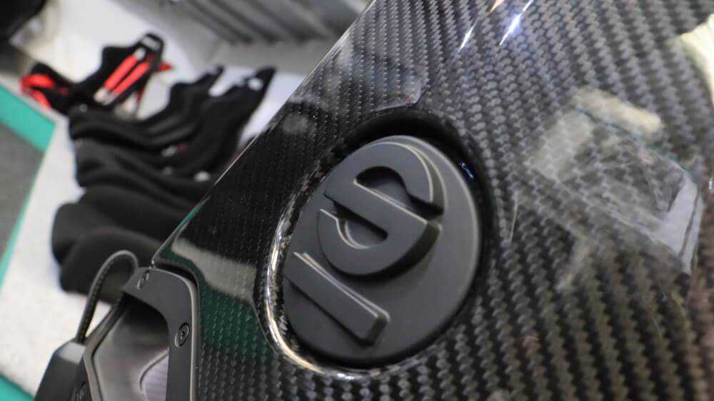 The carbon fibre backrest of a Sparco SPX seat with the Sparco logo, in the showroom