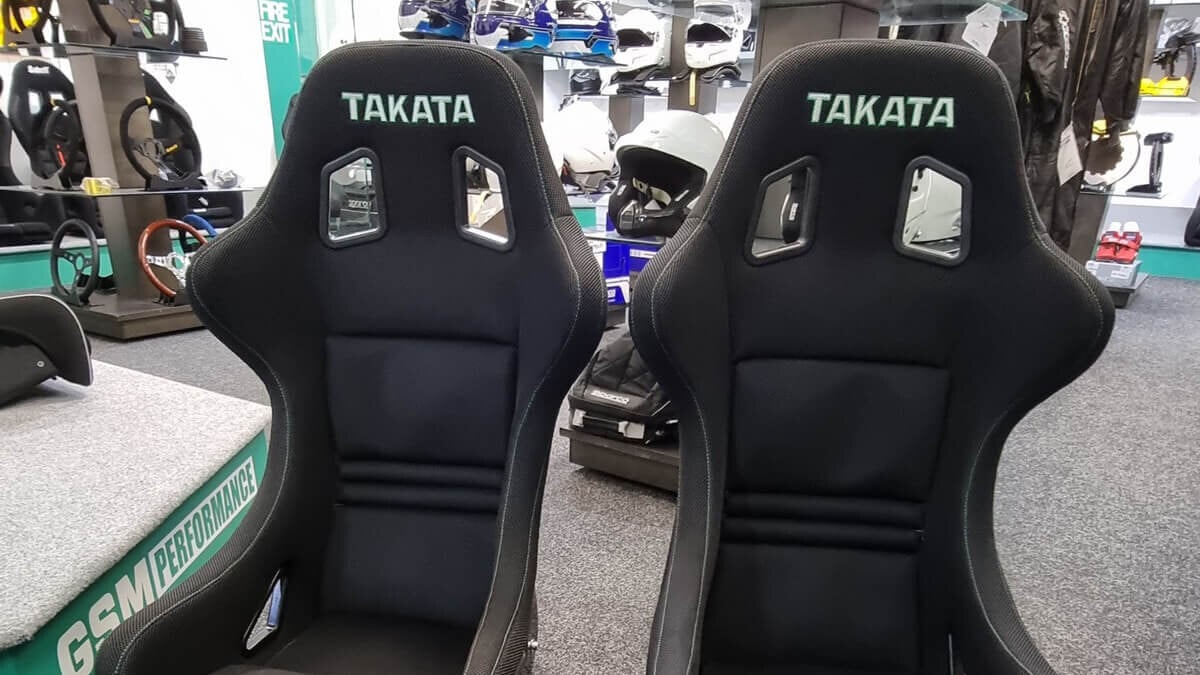 A pair of black Takata Race LE Competition bucket seats on the GSM Performance showroom floor