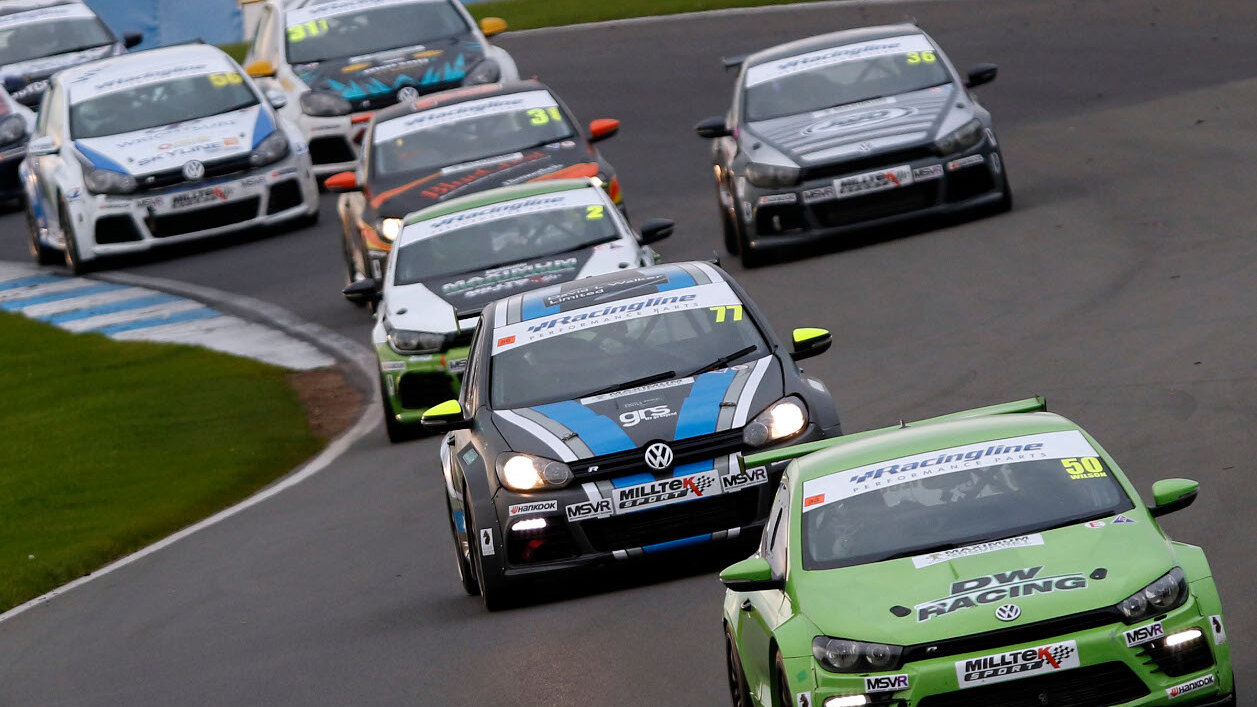 A pack of Volkswagen Scirocco and Golf race cars cornering on a circuit