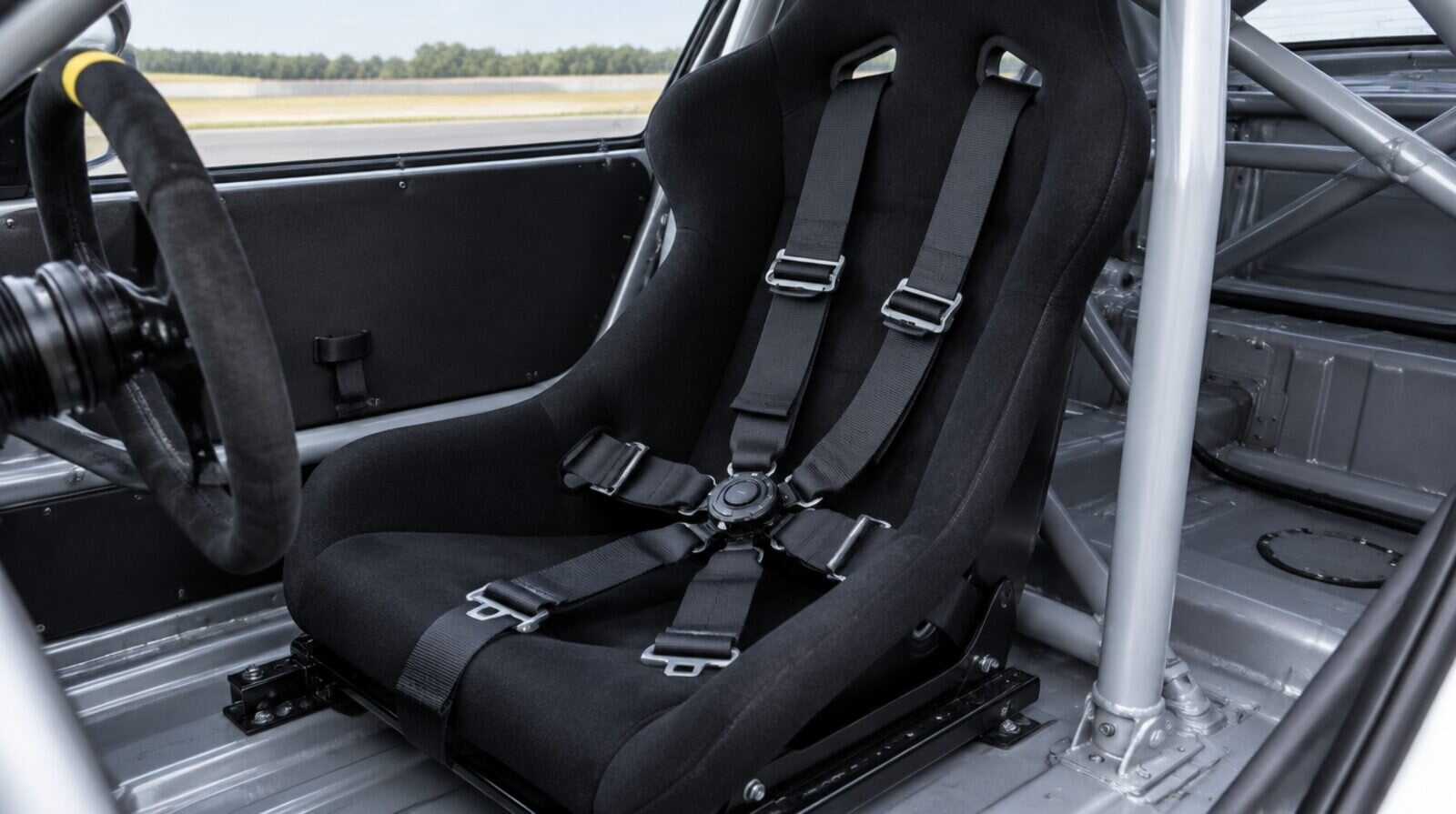 Racing bucket seat and harness fitted in a club race car