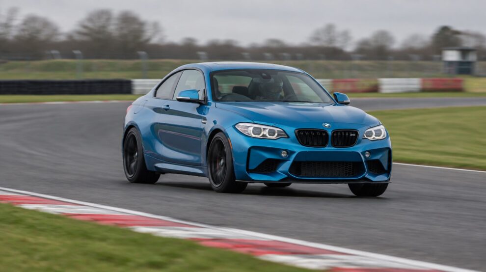 Long Beach Blue BMW M2 F87 cornering on a British race circuit at a track day
