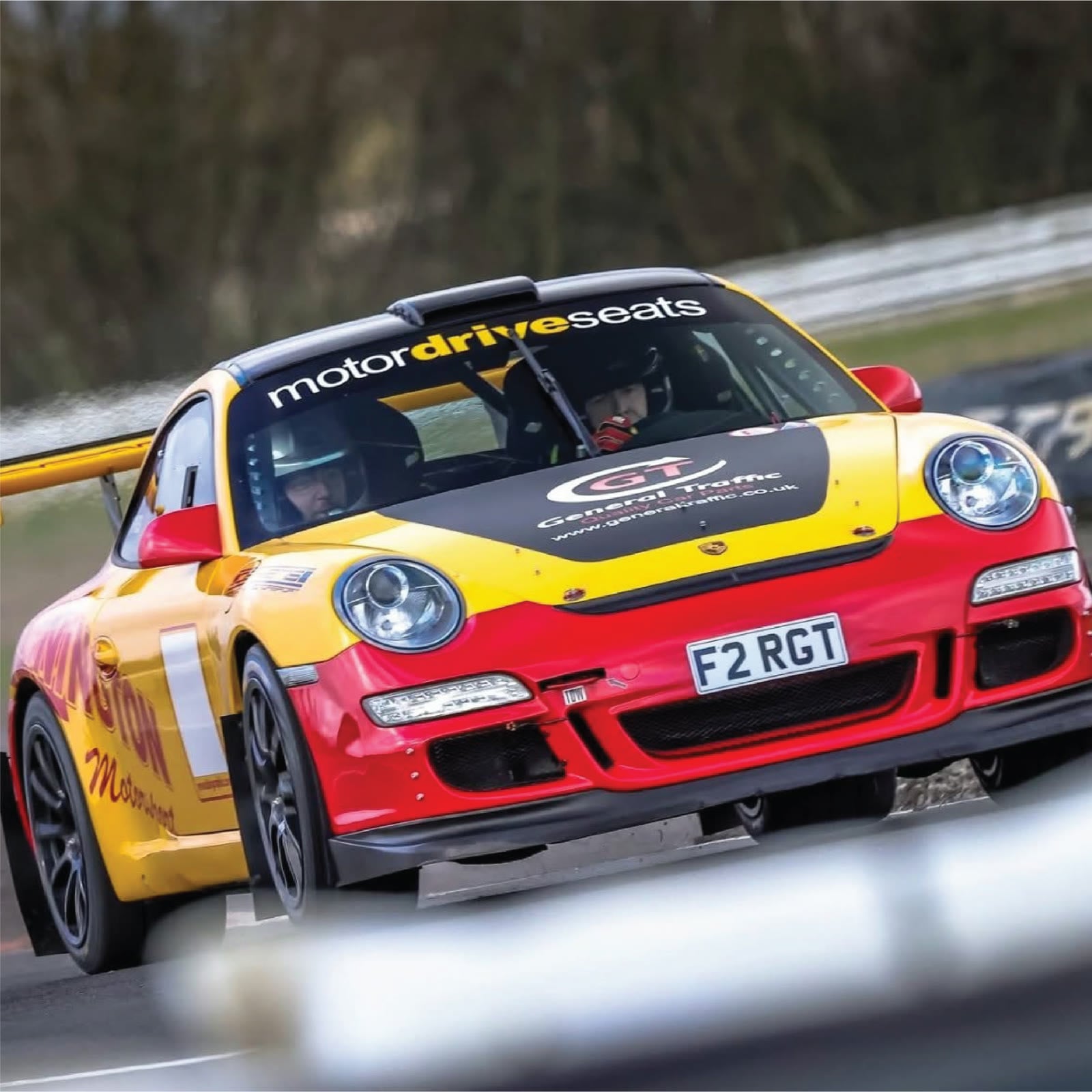 Yellow and red rally car carrying Motordrive branding