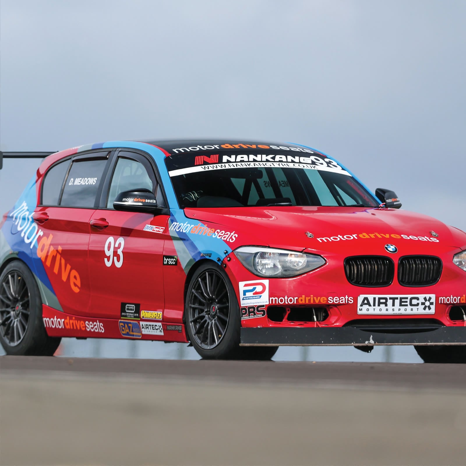 Red and blue number 93 race car with Motordrive branding