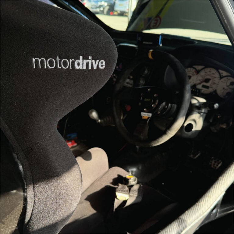 Motordrive seat fitted in a cockpit beside the steering wheel and instruments